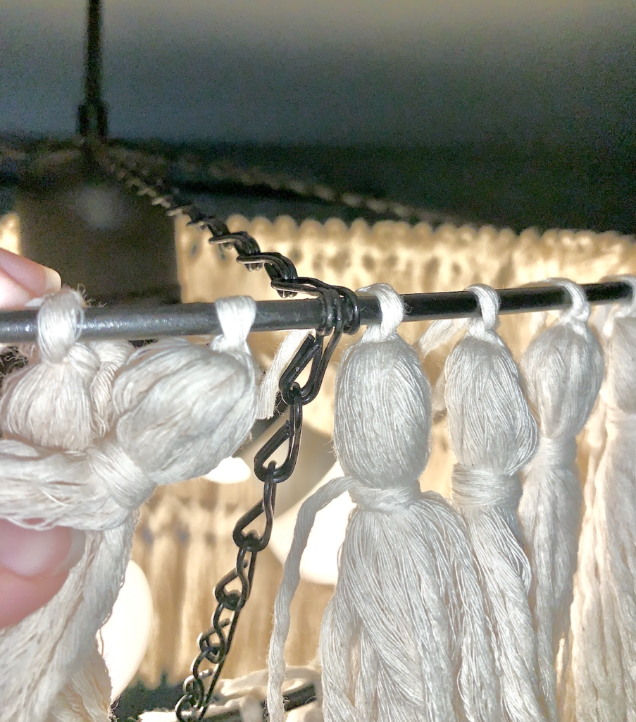 Up close to the tassels and chain linking. 